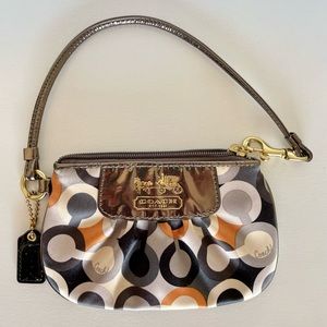 Authentic Coach satin wristlet in brown/gray/rust symbols! Minimal use!